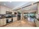 Bright kitchen with stainless steel appliances and stylish tile backsplash, leading to living room at 2834 Pelham N Rd, St Petersburg, FL 33710