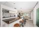 Open floor plan featuring a modern kitchen, a breakfast bar, and an open living room with ocean views at 2834 Pelham N Rd, St Petersburg, FL 33710
