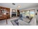 Bright living room with fireplace, custom built-ins, and expansive water views from the large picture window at 2834 Pelham N Rd, St Petersburg, FL 33710