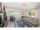 Living room showcases a fireplace, water view window, couch, and patterned rug at 2834 Pelham N Rd, St Petersburg, FL 33710