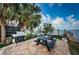 Outdoor dining area with gas grill, wood table and dock access, perfect for entertaining at 2834 Pelham N Rd, St Petersburg, FL 33710