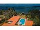 Aerial view of pool, dock, and beautiful water views surrounded by palm trees and lush greenery at 2834 Pelham N Rd, St Petersburg, FL 33710