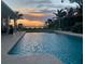 Backyard pool with stunning sunset view over the water and tropical landscaping at 2834 Pelham N Rd, St Petersburg, FL 33710