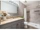 Updated bathroom with gray tiled walk-in shower, modern vanity, and sleek fixtures at 3137 Mission Grove Dr # 3137, Palm Harbor, FL 34684