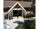 Stone facade entrance to Lake Tarpon Lodge clubhouse, featuring lush landscaping and nearby seating at 3137 Mission Grove Dr # 3137, Palm Harbor, FL 34684