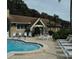 Community pool and Lake Tarpon Lodge clubhouse with poolside seating and lounge chairs at 3137 Mission Grove Dr # 3137, Palm Harbor, FL 34684