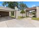 Exterior view showing the carport, walkway, and manicured landscape and lawn at 3137 Mission Grove Dr # 3137, Palm Harbor, FL 34684