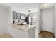 Modern kitchen features gray cabinets, stainless steel appliances, and granite countertops at 3137 Mission Grove Dr # 3137, Palm Harbor, FL 34684