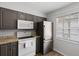 This cozy kitchen features stainless steel appliances, painted wood cabinets, and a window for natural light at 3137 Mission Grove Dr # 3137, Palm Harbor, FL 34684