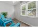 Relax on this lanai with natural light, an exterior door, and comfortable blue outdoor chairs at 3137 Mission Grove Dr # 3137, Palm Harbor, FL 34684