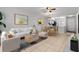 Bright living room with stylish furniture, modern art, and open floor plan to dining area at 3137 Mission Grove Dr # 3137, Palm Harbor, FL 34684
