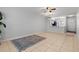 Spacious living room featuring tile flooring, ceiling fan, and open access to the updated kitchen at 3137 Mission Grove Dr # 3137, Palm Harbor, FL 34684