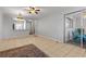 Open-concept living room includes tile flooring, ceiling fan, and slider access to a lanai area at 3137 Mission Grove Dr # 3137, Palm Harbor, FL 34684