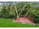 Backyard deck built around several trees offers a place to relax and enjoy nature at 3342 Waterford Dr, Clearwater, FL 33761