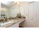 Bathroom vanity featuring a granite countertop, updated fixtures, and ample storage space with nearby closets at 3342 Waterford Dr, Clearwater, FL 33761