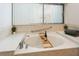 Relaxing bathroom features a large soaking tub beneath a window with vertical blinds at 3342 Waterford Dr, Clearwater, FL 33761