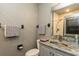 Bathroom vanity with stone countertop, stainless faucet, and framed mirror at 3342 Waterford Dr, Clearwater, FL 33761