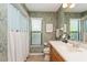 Bathroom featuring a vanity with countertop, a mirror, and a shower with a patterned curtain at 3342 Waterford Dr, Clearwater, FL 33761