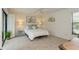 Bright bedroom featuring neutral walls, carpet, a comfortable bed, and a ceiling fan at 3342 Waterford Dr, Clearwater, FL 33761