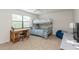 Bedroom displaying a bunk bed, desk, chair, and a window with blinds at 3342 Waterford Dr, Clearwater, FL 33761
