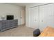 Neutral bedroom featuring a dresser with a TV and a closet with paneled doors at 3342 Waterford Dr, Clearwater, FL 33761