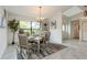 Well-lit dining room featuring a modern chandelier, a large window, and stylish decor for elegant dinners at 3342 Waterford Dr, Clearwater, FL 33761