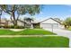 Charming single-story home with stone accents, a well-manicured lawn, and an attached two-car garage at 3342 Waterford Dr, Clearwater, FL 33761