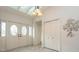 Bright foyer with double entry doors, a modern light fixture, and a decorative metal wall sculpture at 3342 Waterford Dr, Clearwater, FL 33761