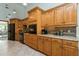 Kitchen showcasing ample wooden cabinetry, a black refrigerator, oven, and granite countertops at 3342 Waterford Dr, Clearwater, FL 33761