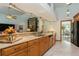 Features granite countertops, breakfast bar, ample wooden cabinetry, and stainless steel appliances at 3342 Waterford Dr, Clearwater, FL 33761