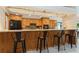 Kitchen view with breakfast bar, complete with granite counters, wooden cabinets, and pendant lighting at 3342 Waterford Dr, Clearwater, FL 33761