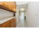 Well-lit laundry room features wood cabinets, ample counter space and modern appliances at 3342 Waterford Dr, Clearwater, FL 33761