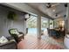 Cozy covered patio with outdoor seating, a grill, and views of the screened pool at 3342 Waterford Dr, Clearwater, FL 33761