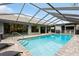 Relaxing screened-in pool surrounded by brick pavers and lounge chairs at 3342 Waterford Dr, Clearwater, FL 33761