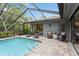 Inviting screened-in pool with brick pavers surrounded by lounge chairs at 3342 Waterford Dr, Clearwater, FL 33761
