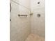 Tiled shower features showerhead and safety bar for easy access at 3342 Waterford Dr, Clearwater, FL 33761