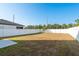 Spacious backyard, with a grass lawn and a sturdy white fence for privacy at 34847 Daisy Meadow Loop, Zephyrhills, FL 33541