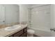 Well-lit bathroom with a shower-tub combination and a single sink vanity at 34847 Daisy Meadow Loop, Zephyrhills, FL 33541