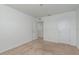 Neutral carpeted bedroom with light walls and an open closet at 34847 Daisy Meadow Loop, Zephyrhills, FL 33541