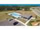 Aerial view of the community pool with lounge chairs and a covered area, plus convenient parking at 34847 Daisy Meadow Loop, Zephyrhills, FL 33541
