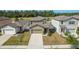 Charming two-story home with a well-maintained lawn and a two-car attached garage at 34847 Daisy Meadow Loop, Zephyrhills, FL 33541