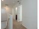 Upstairs hallway with carpet and multiple doors at 34847 Daisy Meadow Loop, Zephyrhills, FL 33541