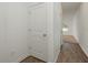Bright hallway with hardwood flooring and white doors, offering a clean and modern aesthetic at 34847 Daisy Meadow Loop, Zephyrhills, FL 33541