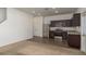 Modern kitchen with stainless steel appliances, dark wood cabinets, and a breakfast bar that enhances functionality at 34847 Daisy Meadow Loop, Zephyrhills, FL 33541