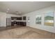 Open-concept space with stainless steel appliances, granite countertops and a large window that enhances natural light at 34847 Daisy Meadow Loop, Zephyrhills, FL 33541