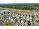 Aerial view showcasing the community with modern homes, green spaces, and nearby highway access at 34847 Daisy Meadow Loop, Zephyrhills, FL 33541