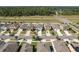 An aerial view of the neighborhood featuring multiple two-story homes near a major roadway at 34855 Daisy Meadow Loop, Zephyrhills, FL 33541