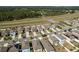 The aerial view of the neighborhood shows rows of two-story homes, and nearby major roadway at 34855 Daisy Meadow Loop, Zephyrhills, FL 33541