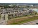 Expansive aerial view of a residential community featuring well-maintained homes, green spaces, and community lakes at 34855 Daisy Meadow Loop, Zephyrhills, FL 33541