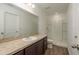 Bathroom featuring a shower, toilet, vanity with sink and a large mirror at 34855 Daisy Meadow Loop, Zephyrhills, FL 33541